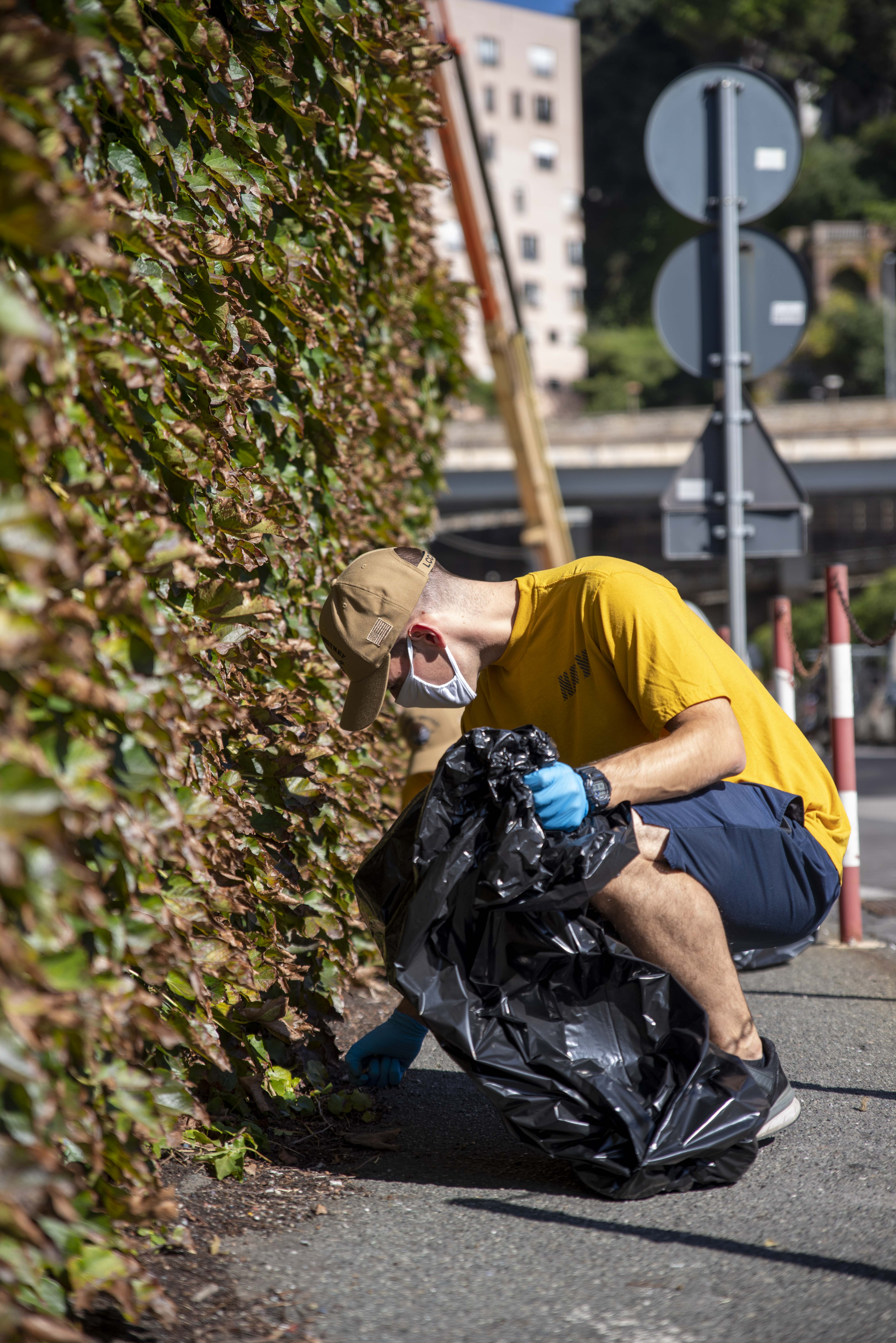 201007-N-EI510-0603 GENOA, Italy (Oct 7, 2020) Hospital Corpsman 3rd Class Donald Cooney, assigned to the Blue Ridge-class command and control ship USS Mount Whitney (LCC 20), picks up trash while attending a community relations event during the ship's dry dock phase in San Giorgio Del Porto in Genoa, Italy, Oct. 7, 2020.  Mount Whitney, the U.S. 6th Fleet flagship, homeported in Gaeta, Italy entered its regularly scheduled overhaul to make improvements in order to increase the security and stability of the U.S. 6th Fleet aera of operations. (U.S. Navy photo by Mass Communication Specialist 2nd Class Scott Barnes)