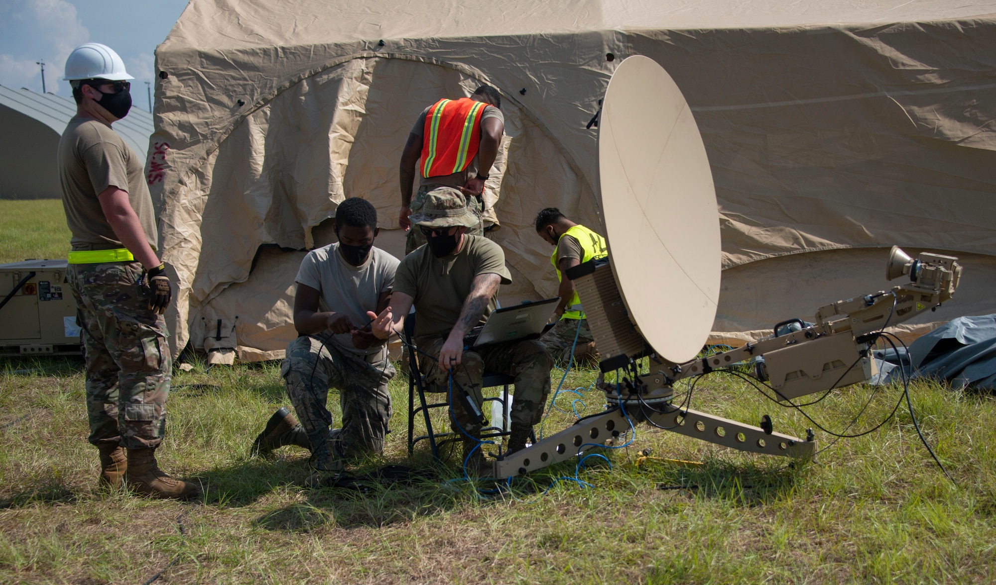 men work on a satellite dish