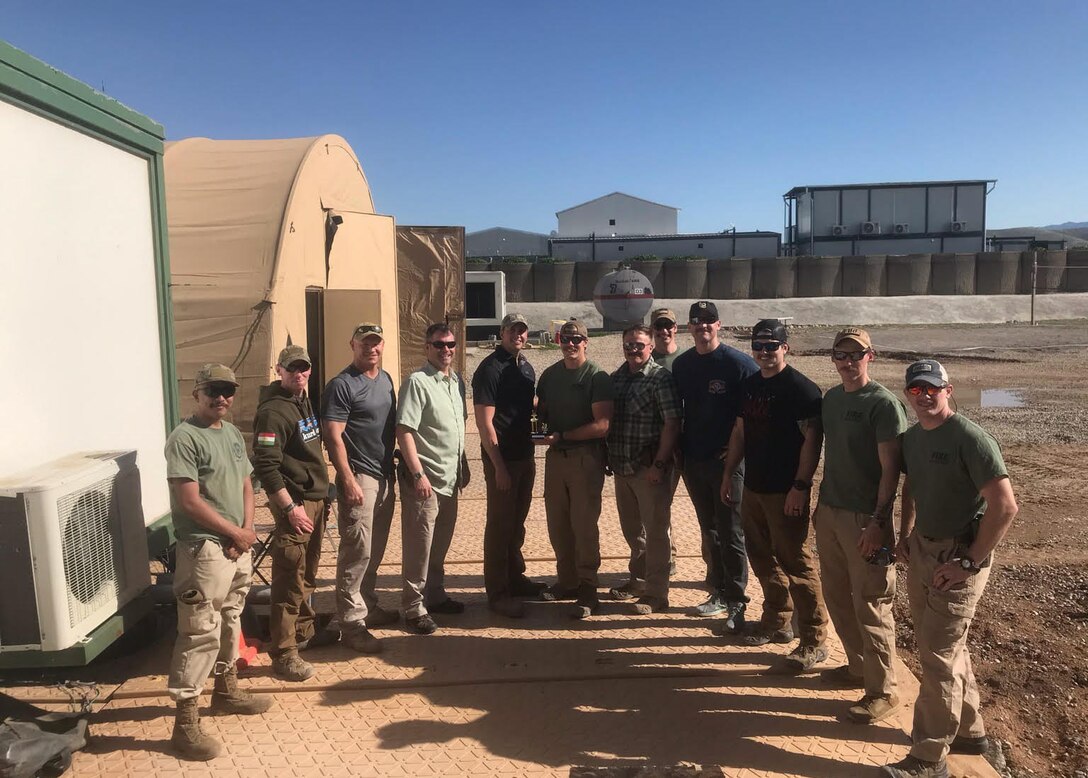 Senior Master Sgt. Rick Johnson, 69th Aerial Port Squadron operations flight chief, poses for a photo with his team while on deployment to Baghdad, Iraq. Johnson was recently awarded the Bronze Star and Air Force Commendation Medal for his heroic efforts and meritorious achievement while deployed in support of Operation Inherent Resolve. (Courtesy Photo)