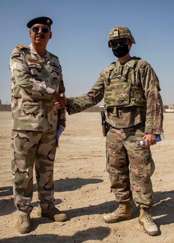 U.S. and Iraqi forces gather for the divestment of equipment from the U.S. government to the government of Iraq at a transfer point near Al Asad Air Base, Iraq, Oct. 15, 2020. Iraqi Maj. Gen. Saadoom Fouad, Q-West Air Base commander, received several containers consisting of air traffic control equipment that will build the Iraqi air force's capability to continue the fight to defeat the Islamic State of Iraq and Syria.(U.S. Army Reserve photo by Spc. Jorge Reyes)