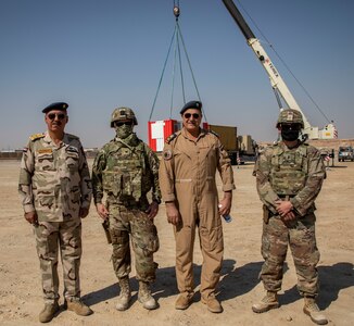 U.S. and Iraqi forces gather for the divestment of equipment from the U.S. government to the government of Iraq at a transfer point near Al Asad Air Base, Iraq, Oct. 15, 2020. Iraqi Maj. Gen. Saadoom Fouad, Q-West Air Base commander, received several containers consisting of air traffic control equipment that will build the Iraqi air force's capability to continue the fight to defeat the Islamic State of Iraq and Syria.(U.S. Army Reserve photo by Spc. Jorge Reyes)