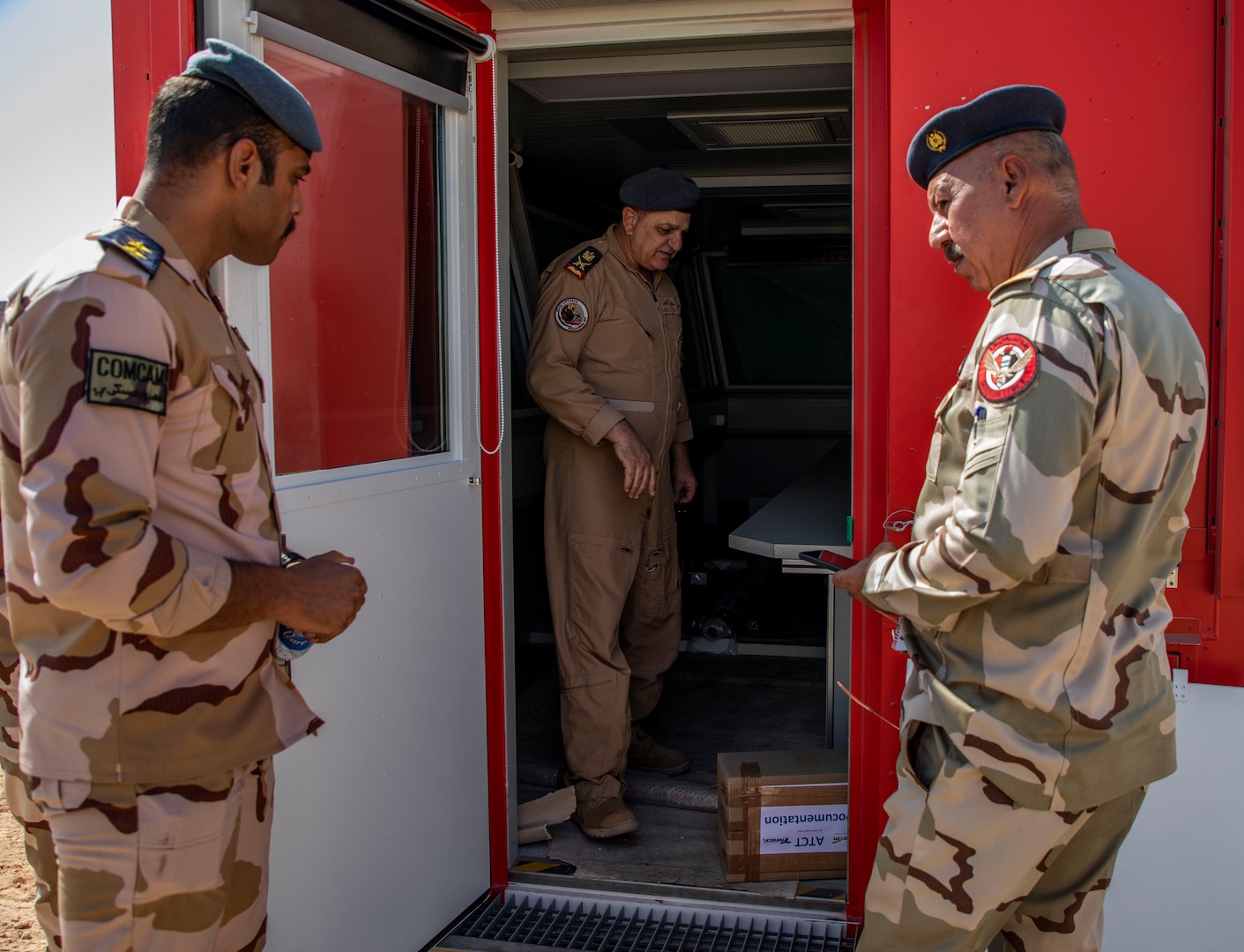 U.S. and Iraqi forces gather for the divestment of equipment from the U.S. government to the government of Iraq at a transfer point near Al Asad Air Base, Iraq, Oct. 15, 2020. Iraqi Maj. Gen. Saadoom Fouad, Q-West Air Base commander, received several containers consisting of air traffic control equipment that will build the Iraqi air force's capability to continue the fight to defeat the Islamic State of Iraq and Syria.(U.S. Army Reserve photo by Spc. Jorge Reyes)