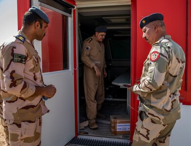 U.S. and Iraqi forces gather for the divestment of equipment from the U.S. government to the government of Iraq at a transfer point near Al Asad Air Base, Iraq, Oct. 15, 2020. Iraqi Maj. Gen. Saadoom Fouad, Q-West Air Base commander, received several containers consisting of air traffic control equipment that will build the Iraqi air force's capability to continue the fight to defeat the Islamic State of Iraq and Syria.(U.S. Army Reserve photo by Spc. Jorge Reyes)
