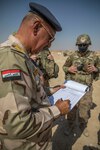 U.S. and Iraqi forces gather for the divestment of equipment from the U.S. government to the government of Iraq at a transfer point near Al Asad Air Base, Iraq, Oct. 15, 2020. Iraqi Maj. Gen. Saadoom Fouad, Q-West Air Base commander, received several containers consisting of air traffic control equipment that will build the Iraqi air force's capability to continue the fight to defeat the Islamic State of Iraq and Syria.(U.S. Army Reserve photo by Spc. Jorge Reyes)