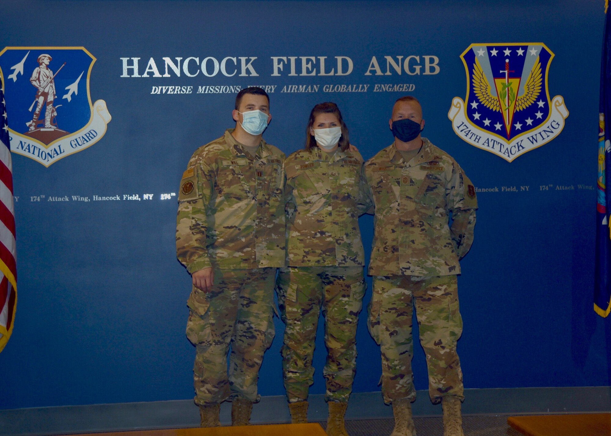 Capt. Devin Will (left), Chief Master Sgt. Michael Will (left), and Staff Sgt. Megan Fowler pose for a photo after Fowler's re-enlistment.