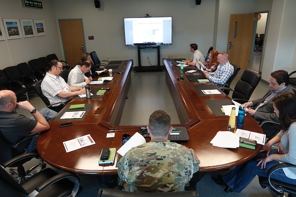 Lt. Col. McGee is seen here holding a traditional staff meeting with his team in Pre-Covid 19 conditions.
