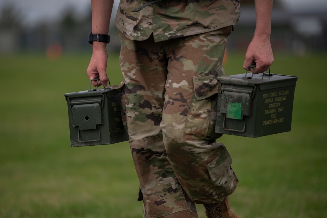 U.S. Air Force Airman 1st Class John Saurusaitis, 48th Healthcare Operations Squadron emergency services technician, Royal Air Force Lakenheath, England, runs with ammunition canisters as part of the Battle of the Badges competition at RAF Mildenhall, England, Oct. 8, 2020. Battle of the Badges is held to build teamwork between police, fire, and medical first-responders. (U.S. Air Force photo by Airman 1st Class Joseph Barron)
