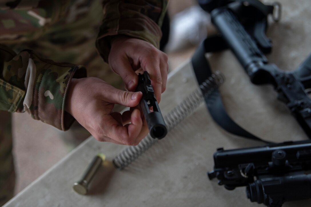 U.S. Air Force Tech. Sgt. Brandon Russell, 100th Security Forces Squadron lead instructor, assembles an M4 carbine rifle during the Battle of the Badges competition at Royal Air Force Mildenhall, England, Oct. 14, 2020. Held simultaneously with the fire muster, Battle of the Badges was organized to encourage camaraderie and teamwork between first-responders. (U.S. Air Force photo by Airman 1st Class Joseph Barron)