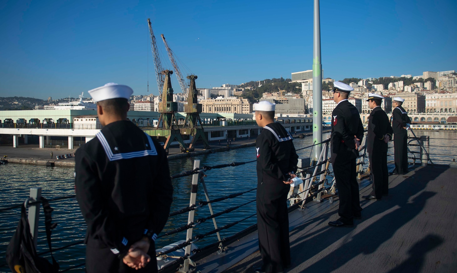 201018-N-KY668-1153 MEDITERRANEAN SEA (Oct. 18, 2020) Sailors man the rails on the missile deck aboard Arleigh Burke-class guided-missile destroyer USS Roosevelt (DDG 80) as the ship pulls into Algiers, Algeria for a scheduled brief stop for fuel, Oct. 18, 2020. Roosevelt, forward-deployed to Rota, Spain, is on its first patrol in the U.S. Sixth Fleet area of operations in support of regional allies and partners and U.S. national security interests in Europe and Africa. (U.S. Navy photo by Mass Communication Specialist Seaman Austin G. Collins/Released)