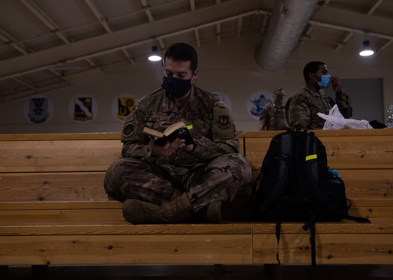 A U.S. Airman from the 606th Air Control Squadron reads a book while waiting to leave for a deployment from Aviano Air Base, Italy, Oct. 10, 2020. The 606th ACS deployed to six locations in Southwest Asia. (U.S. Air Force photo by Senior Airman Caleb House)