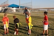 About 15 children maintained social distancing as they circled around their football coaches to receive instructions on their next drill. Conducted from Oct. 5-9, this was the first sports camp held on Joint Base San Antonio-Fort Sam Houston since the novel coronavirus pandemic began earlier this year.

“My overall love for sports is why I volunteer,” said Maj. John Twitty, U.S. Army South public affairs plans chief. “I want to teach kids the proper fundamentals and the importance of working together. It was special to be a part of coaching them and continue to have a strong tie with local community.”