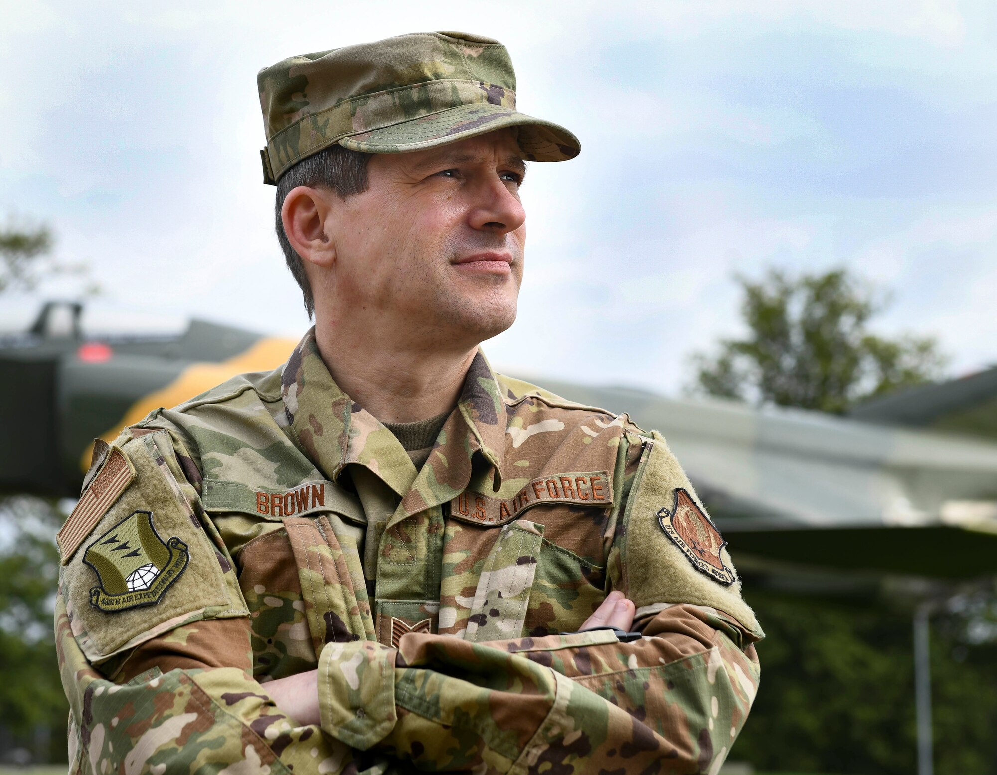 Tech. Sgt. Michael Brown, 435th Air Expeditionary Wing client systems craftsman, poses for a photo in front of a static aircraft at Ramstein Air Base, Germany, Oct. 1, 2020. Brown has been in the military for three decades and has served in three different branches to include the U.S. Marine Corps, the Army National Guard and presently in the Air National Guard. (U.S. Air Force photo by Senior Airman Madeline Herzog)