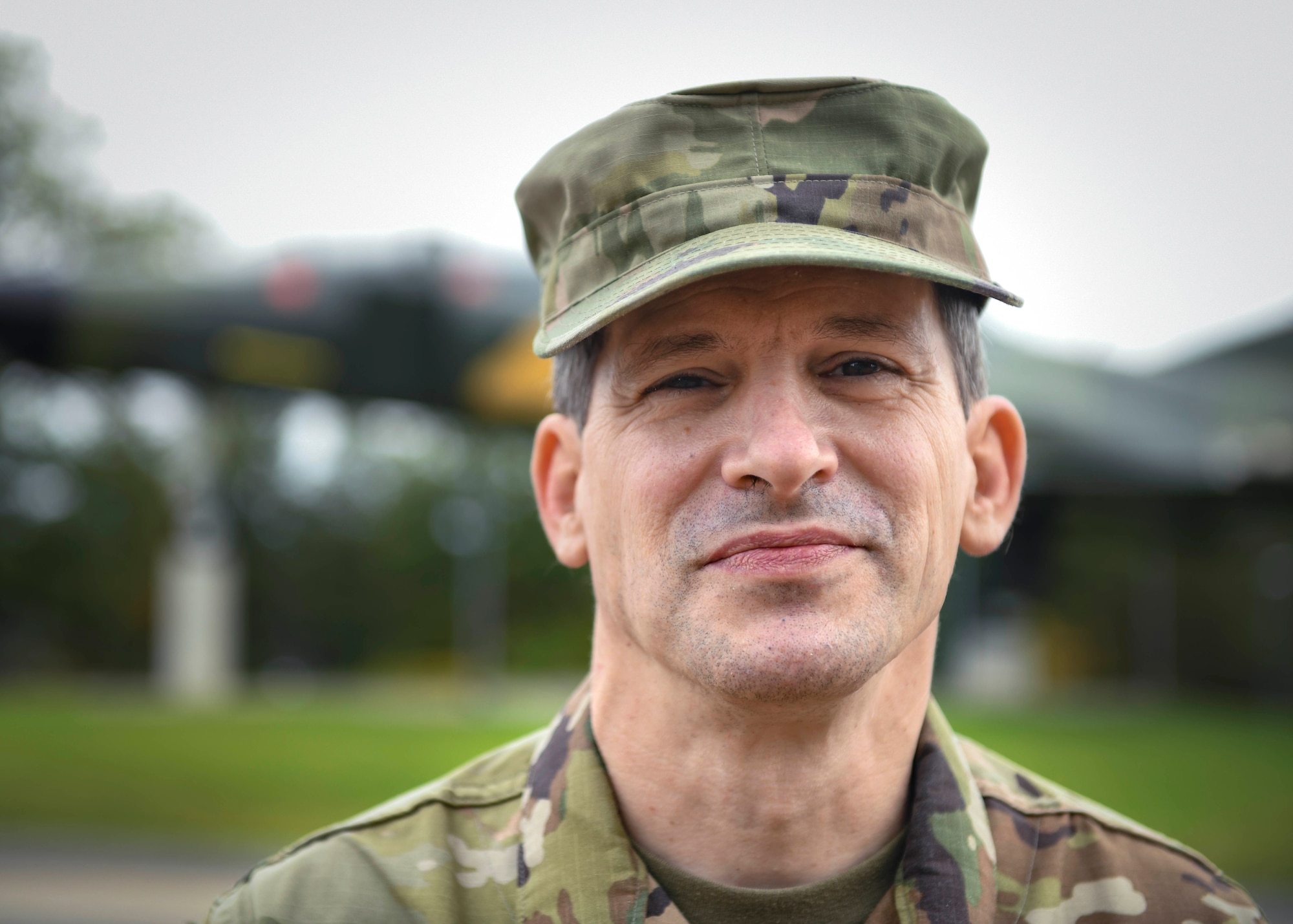 Tech. Sgt. Michael Brown,  435th Air Expeditionary Wing client systems craftsman, poses for a photo in front of a static aircraft at Ramstein Air Base, Germany, Oct. 1, 2020. Brown enlisted in the military in 1984 and has served  for about 30 years  in three different branches.  (U.S. Air Force photo by Senior Airman Madeline Herzog)