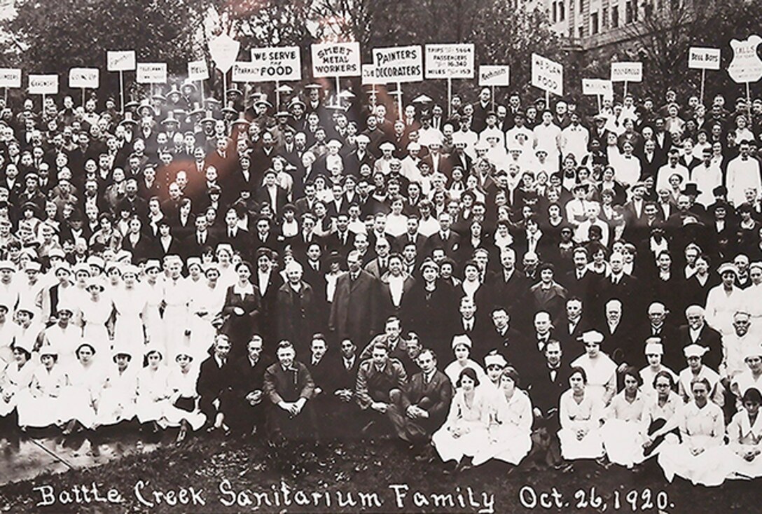 a few hundred men and women standing and sitting in 1920's clothing looking towards the camera. Some are doctors and nurses others labors.