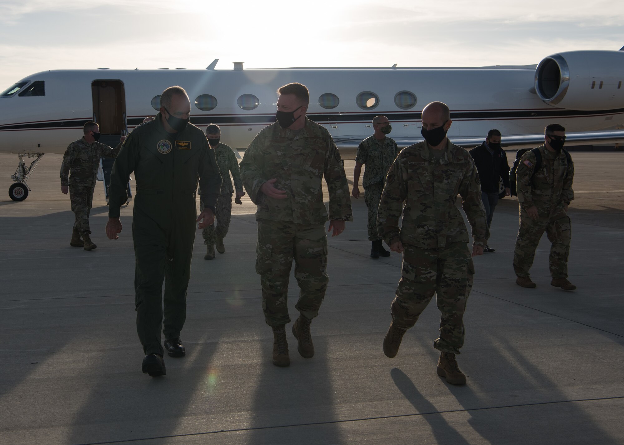 Admiral Charles Richard, U.S. Strategic Command commander, and Whiteman Air Force Base leaders walk away from his aircraft.