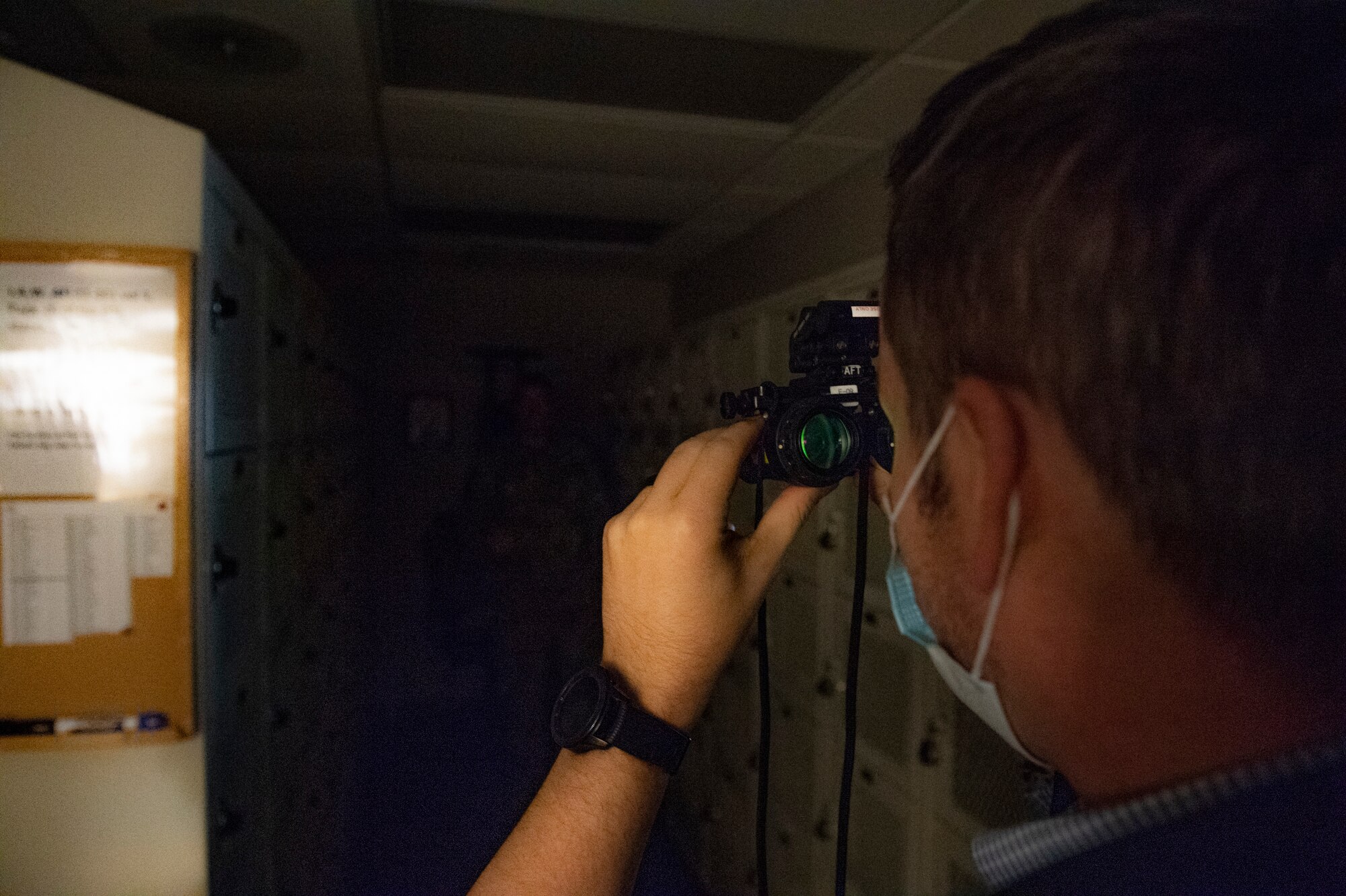Richard Callis, manpower management officer with the 911th Force Support Squadron, observes Senior Airman Sam Phillippi, 911th Operations Support Squadron aircrew flight equipment technician, through night vision goggles at the Pittsburgh International Airport Air Reserve Station, Pennsylania, Oct. 2, 2020.