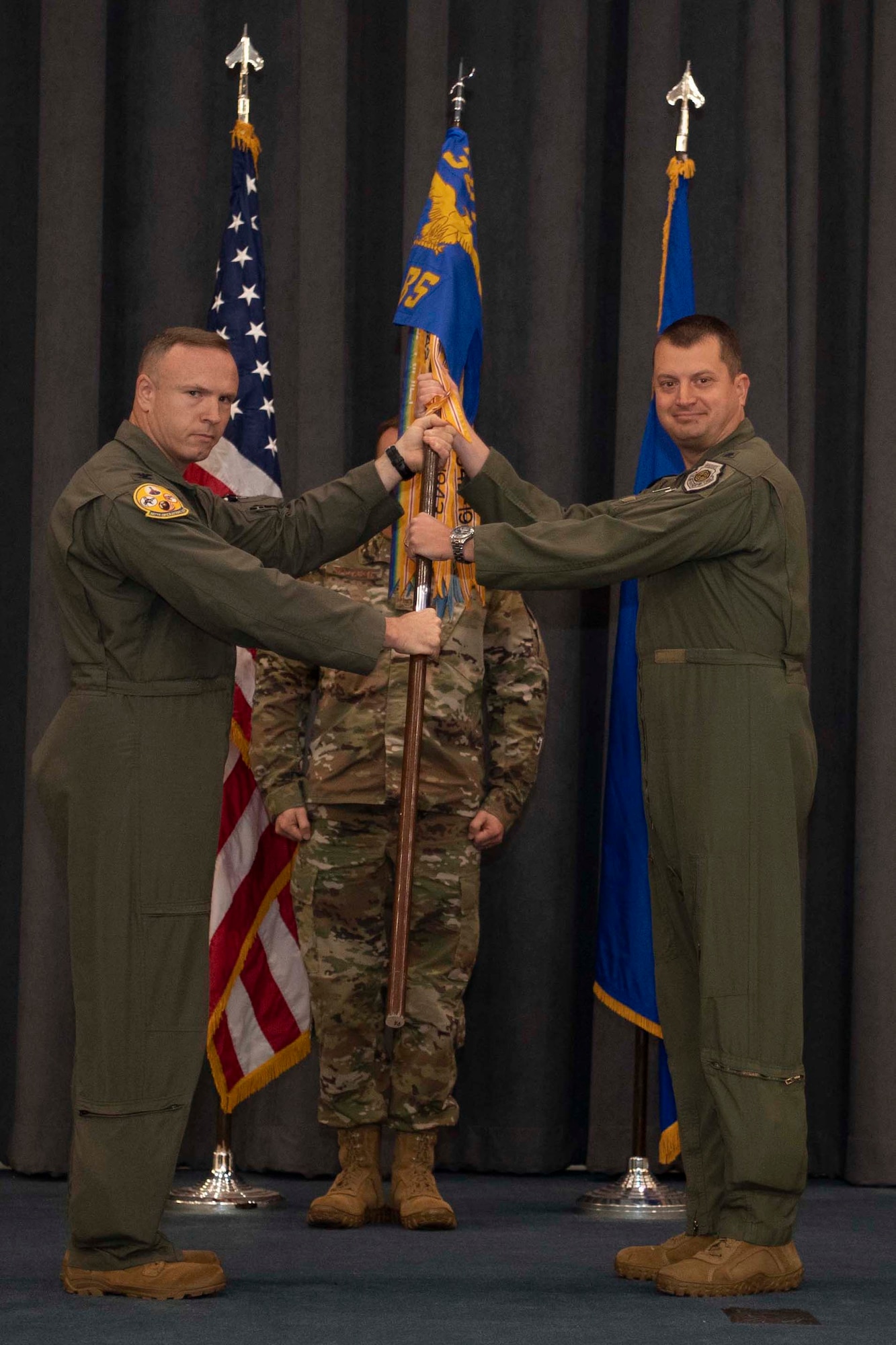 Airmen exchange a unit guidon.