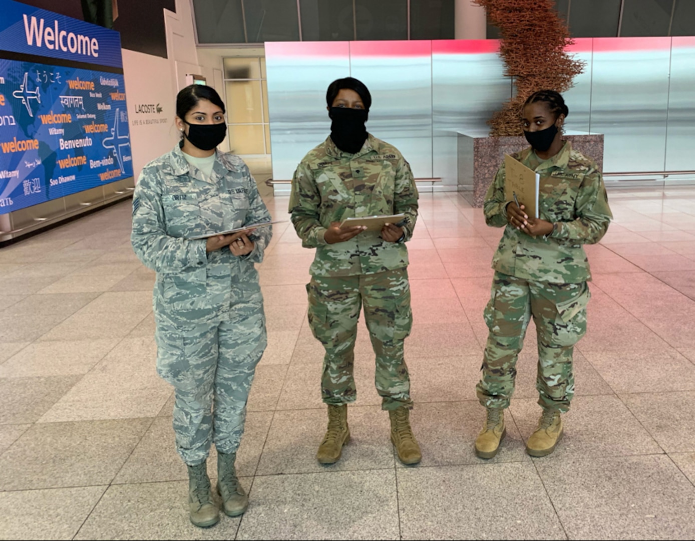 Members of the New York National Guard help state Department of Health officials screen travelers at JFK Airport in New York City Oct. 16. 2020. Travelers arriving from states with significant community spread are advised to quarantine for 14 days as a precaution.