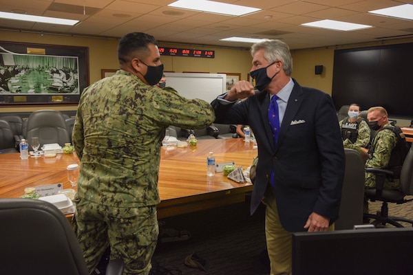 Secretary of the Navy Kenneth J. Braithwaite greets Sailors with an elbow bump during a visit to Joint Region Marianas.