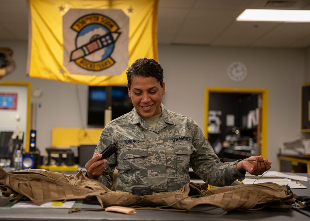 Airman 1st Class Adena Torres, 4th Operations Support Squadron aircrew flight equipment technician, inspects the survival vest of an F-15E Strike Eagle pilot at Seymour Johnson Air Force Base, North Carolina, Sept. 8, 2020.