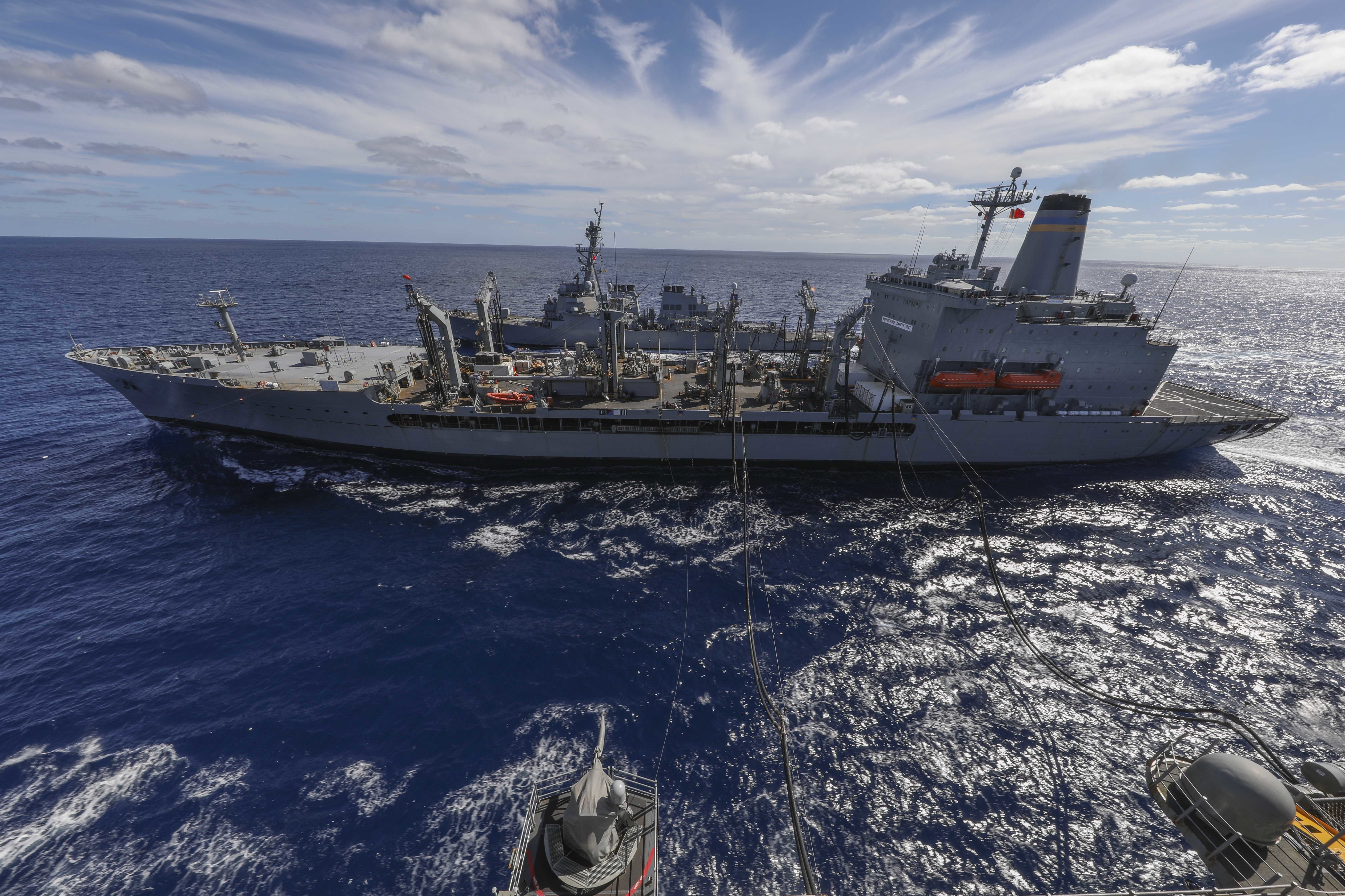 The Arleigh Burke-class guided-missile destroyer USS Arleigh Burke (DDG 51), top, and the Wasp-class amphibious assault ship USS Iwo Jima (LHD 7) conduct an underway replenishment with Henry J. Kaiser-class fleet replenishment oiler USNS Kanawha (T-AO 196) in the Atlantic Ocean during their Surface Warfare Advance Tactical Training (SWATT), Oct. 15, 2020.