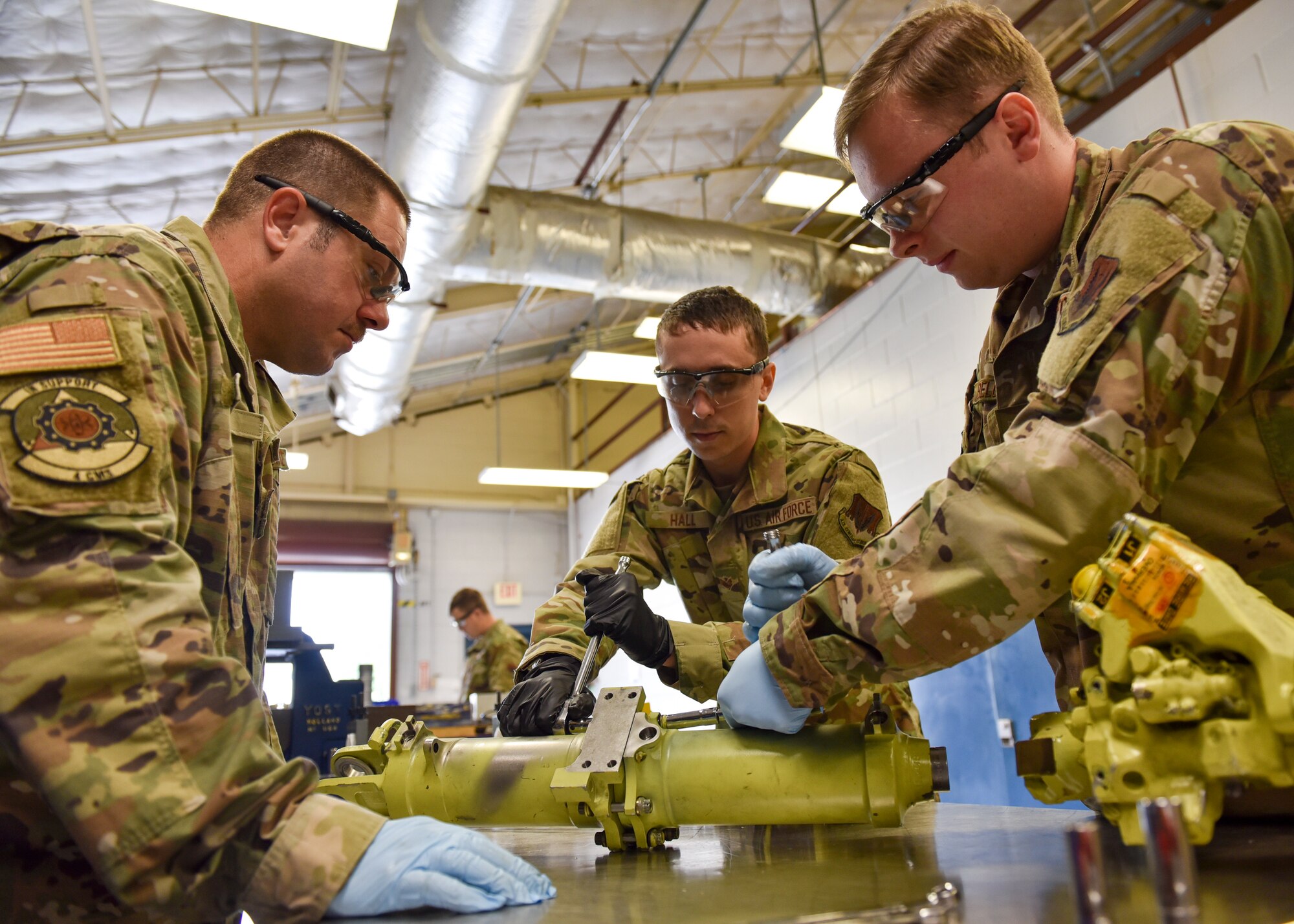 Airmen from the 4th Component Maintenance Squadron hydraulics shop work on an F-15E Strike Eagle servocylinder hydraulic stabilator actuator at Seymour Johnson Air Force Base, North Carolina, Sept. 16, 2020.