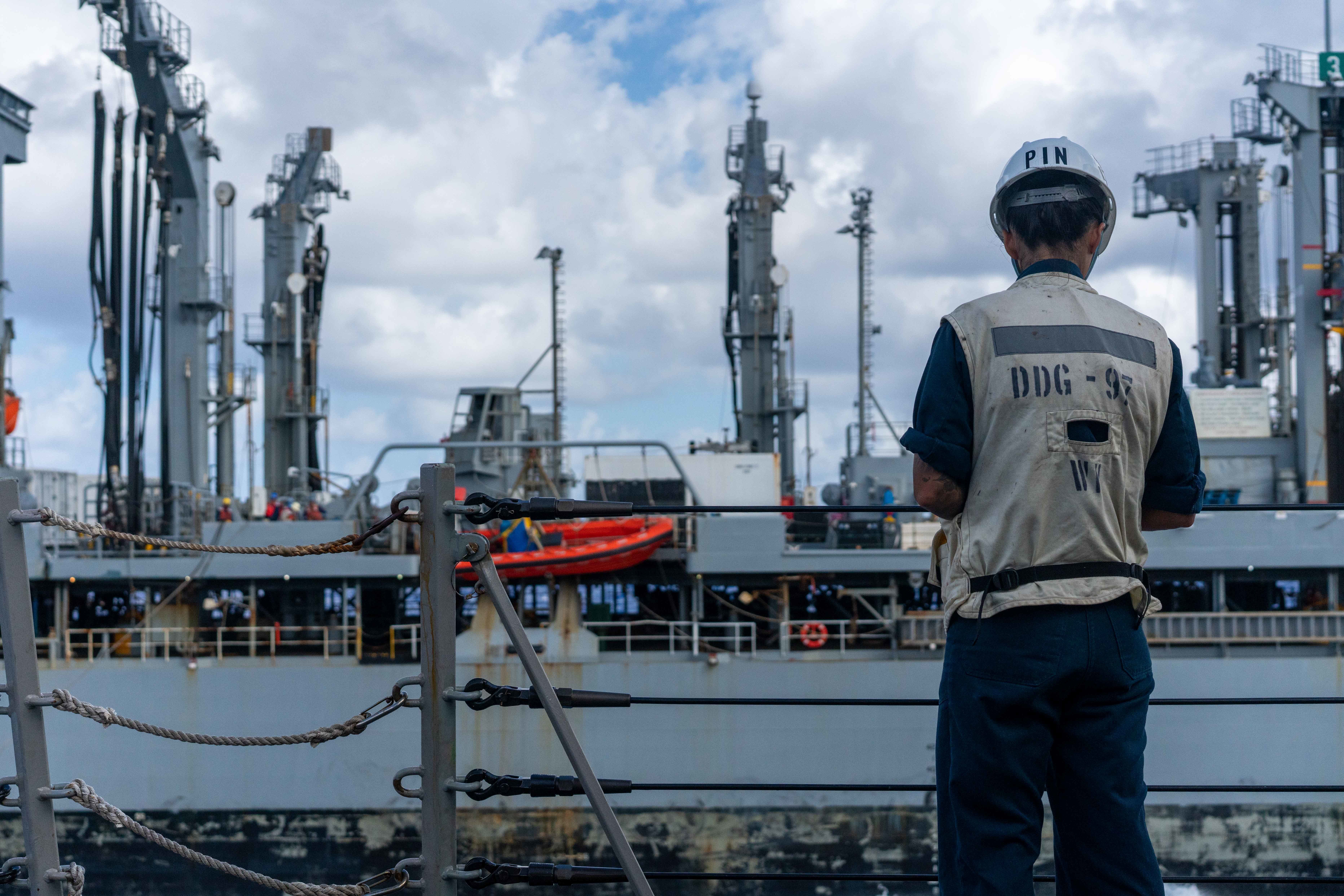 Hospital Corpsman 2nd Class Elizabeth Pinon, from Los Angeles, Calif., observes a replenishment-at-sea (RAS) between the Henry J. Kaiser-class underway replenishment oiler USNS Pecos (T-AO-197)