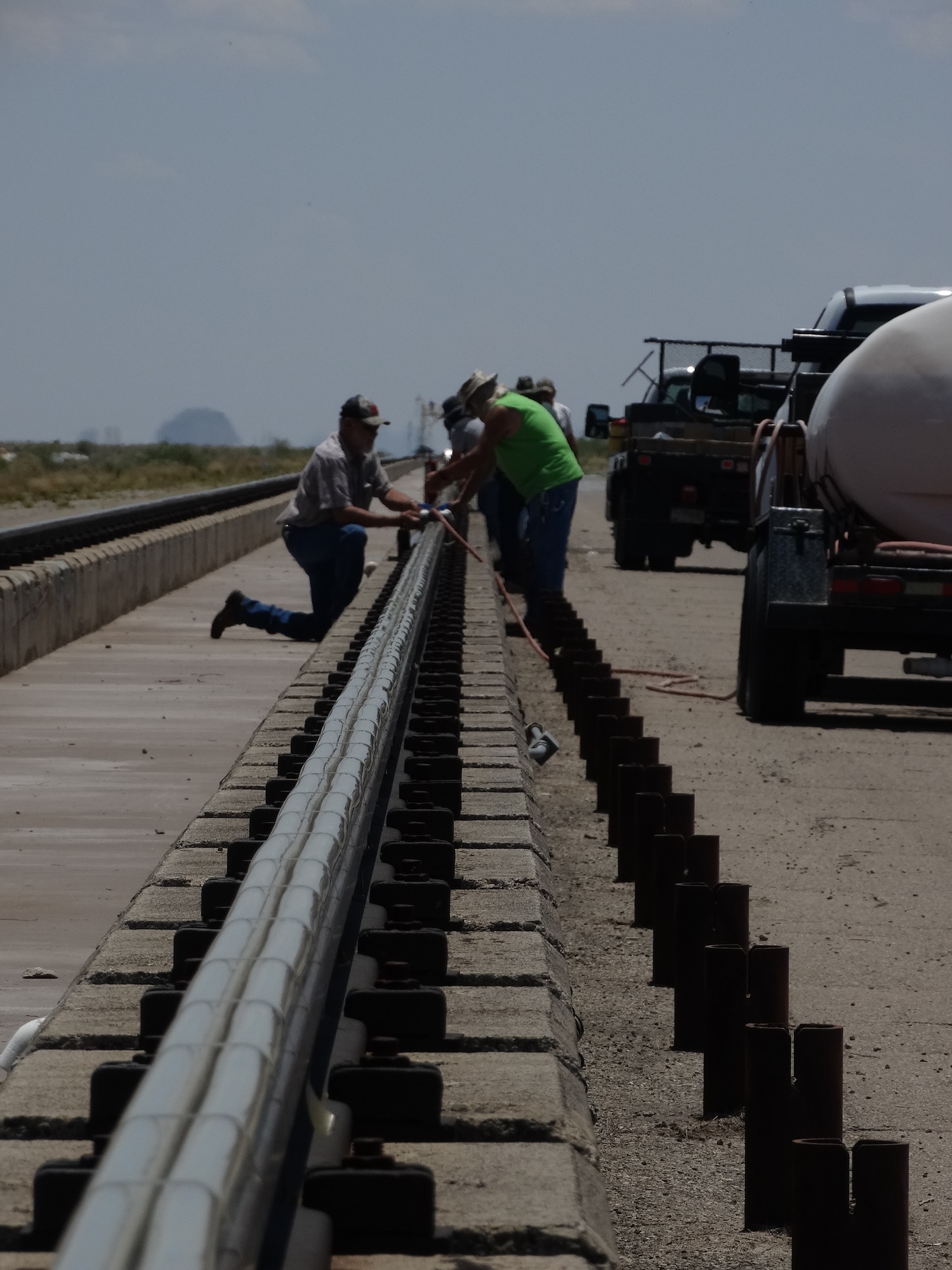 Rail-top water bags used as part of the rocket sled braking system are placed along the Holloman High Speed Test Track at Holloman Air Force Base, New Mexico. Since last summer, several tests have been conducted at the track as part of the Hypersonic Readiness program. This program, an initiative of the 846th Test Squadron, is a series of tests preparing for future rocket sled testing. (U.S. Air Force photo)