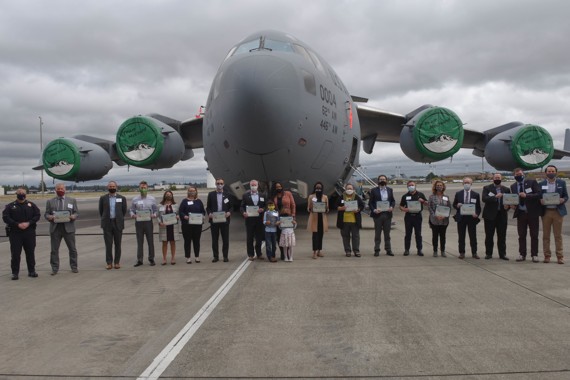 Honorary commanders for term 2020-2022 pose for a group photo in front of a C-17 Globemaster III.