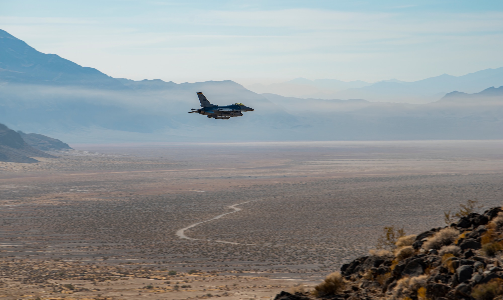 F-16 flies over range.