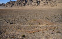 Airmen walk up a hill.
