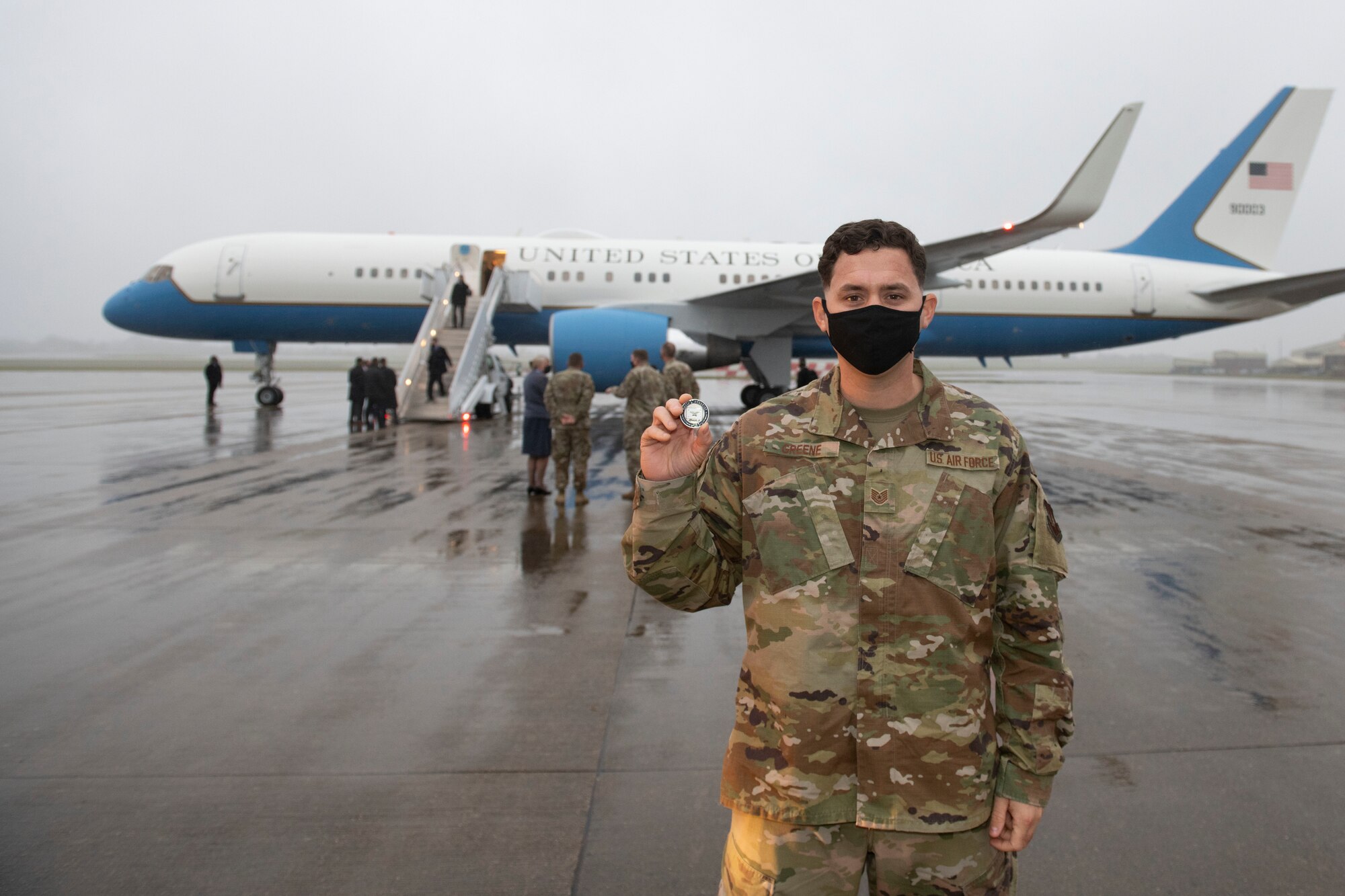 U.S. Air Force Tech. Sgt. Houston Greene, 420th Air Base Squadron flight chief of sustainment, poses for a photo with a coin of excellence from Deputy Secretary of Defense David L. Norquist at RAF Fairford, England, Oct. 12, 2020. Greene was recognized for leading a $2 million dining facility renovation at RAF Fairford in support of Bomber Task Force Europe 2020. (U.S. Air Force photo by Senior Airman Jennifer Zima)