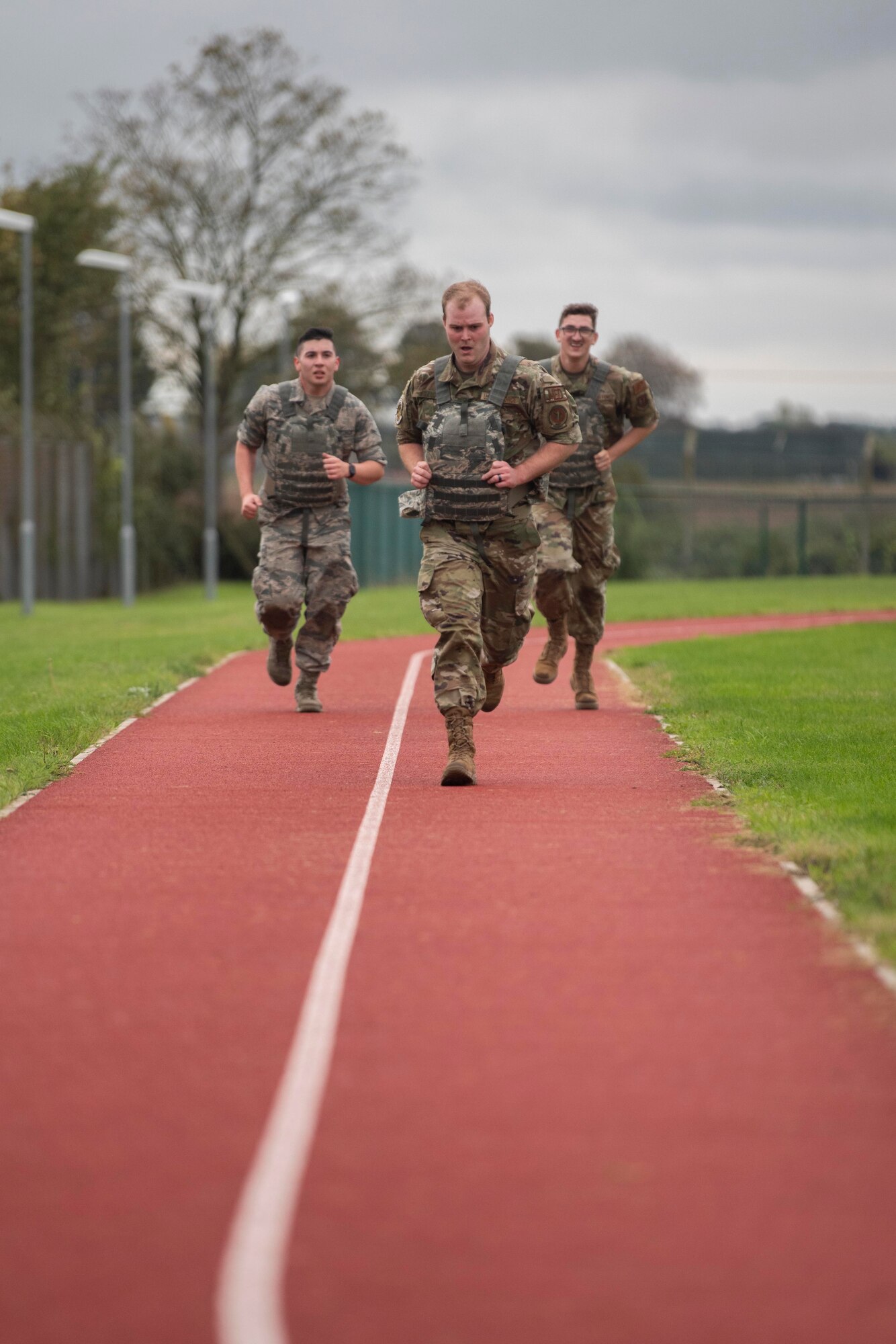 U.S. Air Force Airman Daniel Garcia, 48th Medical Support Squadron records technician, Royal Air Force Lakenheath, England, left, Staff Sgt. Gary Willis, 48th Healthcare Operations Squadron  paramedic, center, and Airman 1st Class John Saurusaitis, 48th HOS  emergency services technician, run as part of the Battle of the Badges competition at RAF Mildenhall, England, Oct. 8, 2020. The competition included challenges like a weapons breakdown, timed donning of chemical, biological, radiological, and nuclear gear, and running. (U.S. Air Force photo by Airman 1st Class Joseph Barron)