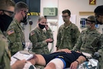 Students in the Combat Medic Specialist Training Program, or CMSTP, assess a simulated casualty during a field training exercise at Joint Base San Antonio-Camp Bullis. Face coverings are required by all students and staff in accordance with Centers for Disease Control and Prevention guidelines. During the last two weeks of training, CMSTP students prepare for and conduct a non-stop, 72-hour operational exercise during which they are assessed on all the skills learned since their first day. (Photo by Lee Crawford)