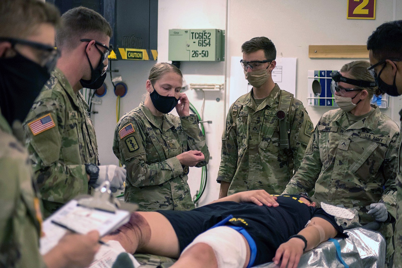 Students in the Combat Medic Specialist Training Program, or CMSTP, assess a simulated casualty during a field training exercise at Joint Base San Antonio-Camp Bullis.