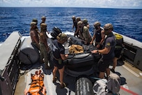 Marines and Sailors assigned to Task Force Ellis and Commander, Task Force 75 aboard Patrol Boat (PB) Mk VI prepare to conduct a launch and recovery exercise of a combat rubber raiding craft during maritime operations.