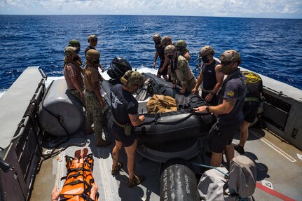 Marines and Sailors assigned to Task Force Ellis and Commander, Task Force 75 aboard Patrol Boat (PB) Mk VI prepare to conduct a launch and recovery exercise of a combat rubber raiding craft during maritime operations.