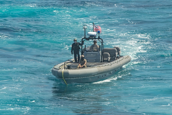 Sailors and Coast Guardsmen conduct small boat operations aboard the Independence-class littoral combat ship USS Gabrielle Giffords (LCS 10) Oct. 10, 2020.