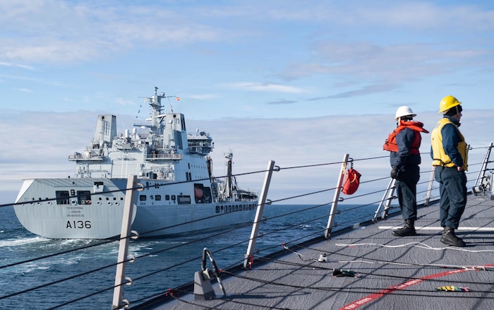 200909-N-TC847-1006 BARENTS SEA (Sept. 9, 2020) Sailors assigned to the Arleigh Burke-class guided-missile destroyer USS Ross (DDG 71) approach the British Royal Fleet Auxiliary tanker RFA Tidespring (A136) for a replenishment-at-sea in the Barents Sea, Sept. 9, 2020. Ross is conducting maritime security operations in the Barents Sea as part of a Surface Action Group with the Royal Navy and Royal Norwegian Navy. (U.S. Navy photo by Mass Communication Specialist Seaman Christine Montgomery)