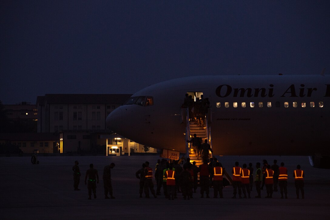 Members of the 606th Air Control Squadron board a plane for a deployment from Aviano Air Base, Italy, Oct. 10, 2020. The 606th ACS is comprised of U.S. Airmen from more than two dozen different Air Force specialty codes. (U.S. Air Force photo by Senior Airman Caleb House)