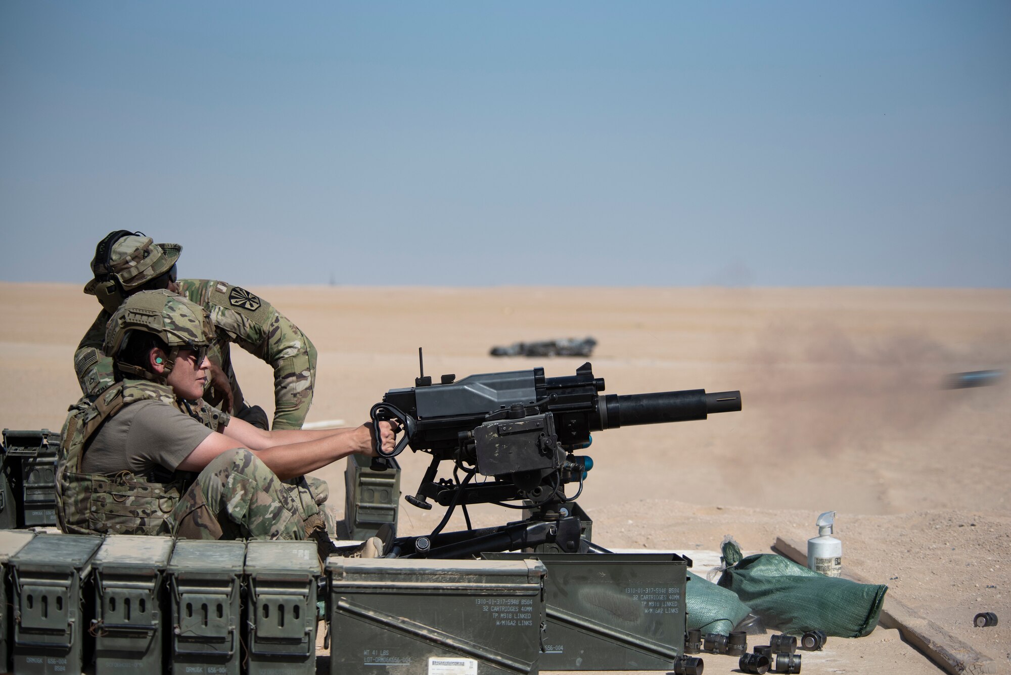 U.S. Air Force Senior Airman Monica Roybal, 386th Air Expeditionary Wing Public Affairs photojournalist, fires an MK-47 automatic grenade launcher at the Udairi Range Complex, Kuwait, Oct. 12, 2020.