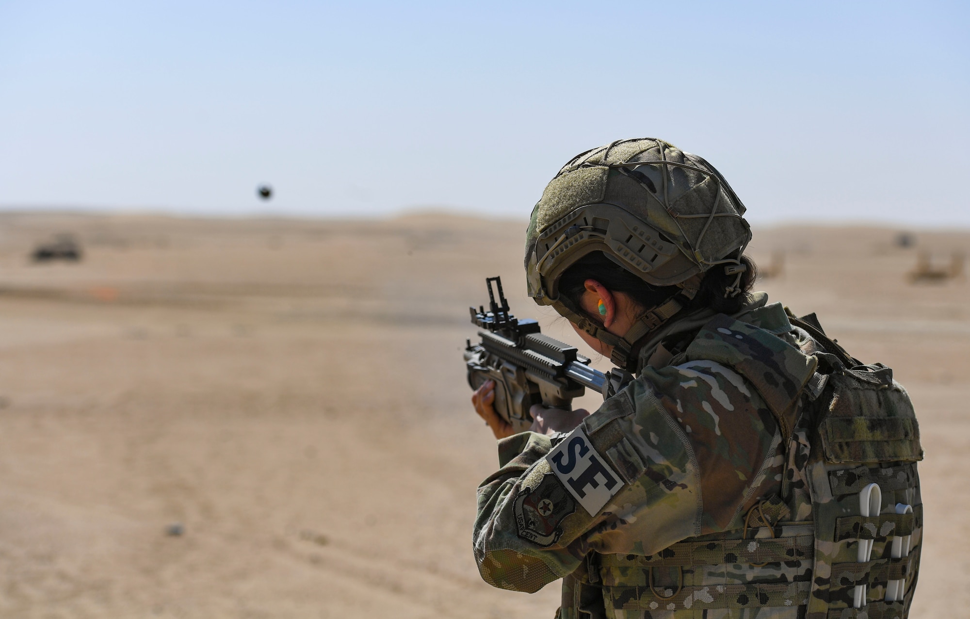 U.S. Air Force Airman 1st Class Miabella Contreras, 386th Expeditionary Security Forces Squadron Operations Raptor Flight response force leader, fires an MK-13 single grenade launcher at the Udairi Range Complex, Kuwait, Oct. 12, 2020.