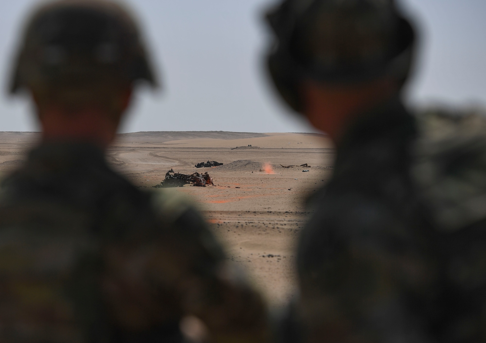 Firing range participants watch a target at the Udairi Range Complex, Kuwait, Oct. 12, 2020.