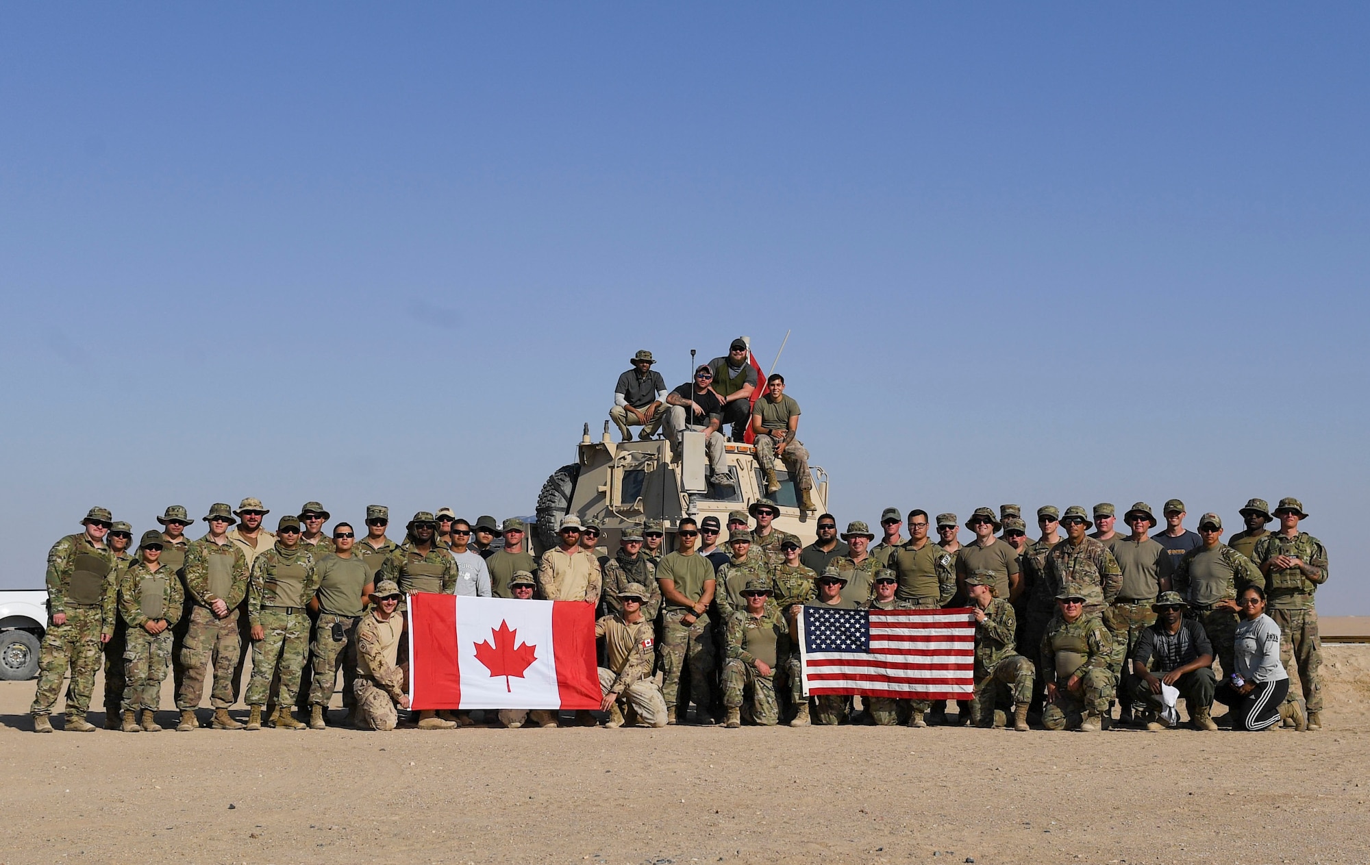 U.S. Army Soldiers, U.S. Air Force Airmen and Canadian Armed Forces members pose for a photo at the Udairi Range Complex, Kuwait, Oct. 12, 2020.