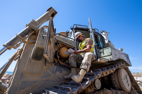 200910-N-RH019-0001 ROTA, Spain, (Sept. 10, 2020) Equipment Operator Constructionman Micah Slicer from Palm Coast, Fla. attached to Naval Mobile Construction Battalion (NMCB) 133 conducts daily maintenance on a D6T Dozer during coastal erosion restoration onboard Naval Air Station Rota, Sept. 10, 2020. CTF 68 provides explosive ordnance disposal operations, naval construction, expeditionary security, and theater security efforts in the 6th Fleet area of responsibility. (U.S. Navy photo by Mass Communication Specialist 2nd Class Sean Rinner/Released)