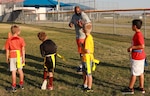 Football coach with kids