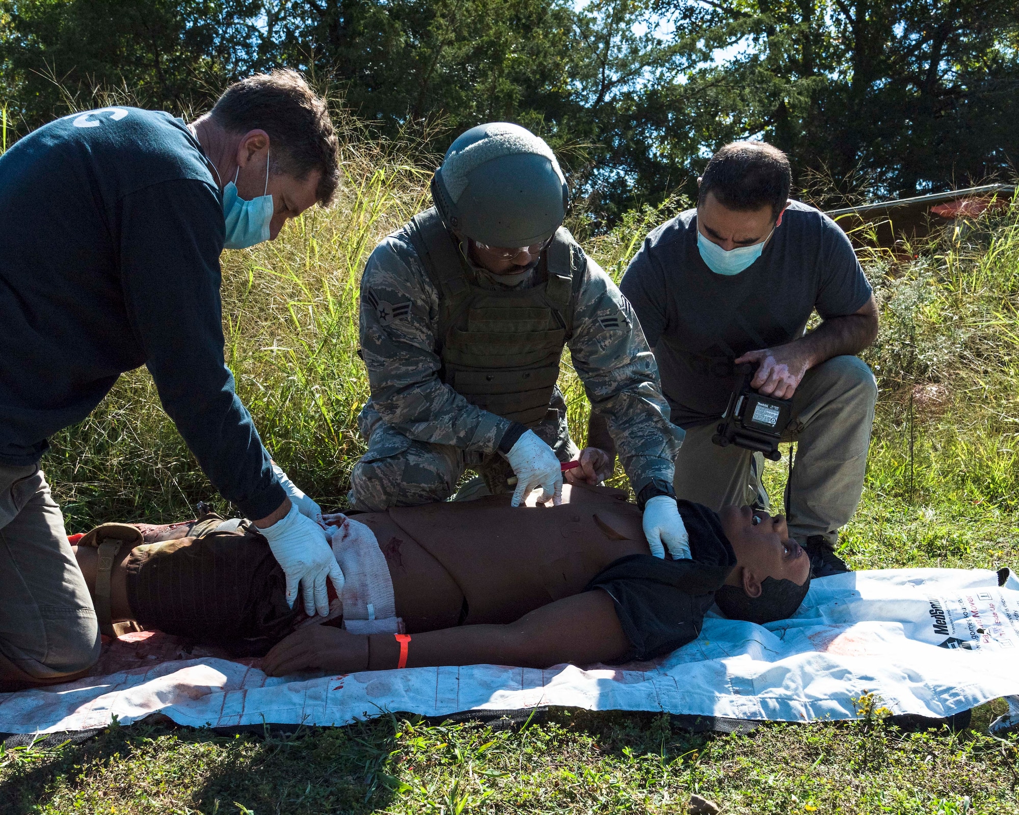 Total Force medical personnel from Little Rock Air Force Base, Ark., treat a wounded training mannequin during the Tactical Combat Casualty Care Course final exam on base, Oct. 16, 2020. Fifteen medics from Air Force active duty, Reserve and Guard units completed the course, which was facilitated by the 19th Medical Group, local Metropolitan Emergency Medical Services and supported by Air National Guard security forces members. The training prepares medical professionals to perform in an austere combat environment. (U.S. Air Force Reserve photo by Maj. Ashley Walker)