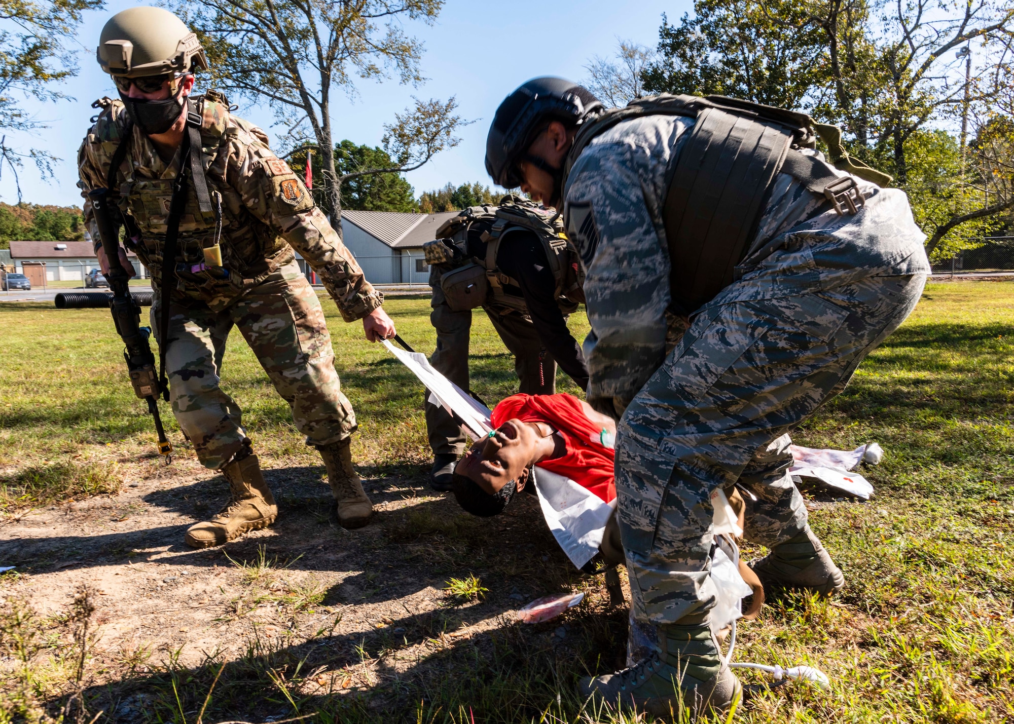 Total Force medical personnel from Little Rock Air Force Base, Ark., drag a wounded training mannequin to safety during the Tactical Combat Casualty Care Course final exam on base, Oct. 16, 2020. Fifteen medics from Air Force active duty, Reserve and Guard units completed the course, which was facilitated by the 19th Medical Group, local Metropolitan Emergency Medical Services and supported by Air National Guard security forces members. The training prepares medical professionals to perform in an austere combat environment. (U.S. Air Force Reserve photo by Maj. Ashley Walker)