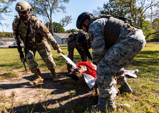 Total Force medical personnel from Little Rock Air Force Base, Ark., drag a wounded training mannequin to safety during the Tactical Combat Casualty Care Course final exam on base, Oct. 16, 2020. Fifteen medics from Air Force active duty, Reserve and Guard units completed the course, which was facilitated by the 19th Medical Group, local Metropolitan Emergency Medical Services and supported by Air National Guard security forces members. The training prepares medical professionals to perform in an austere combat environment. (U.S. Air Force Reserve photo by Maj. Ashley Walker)