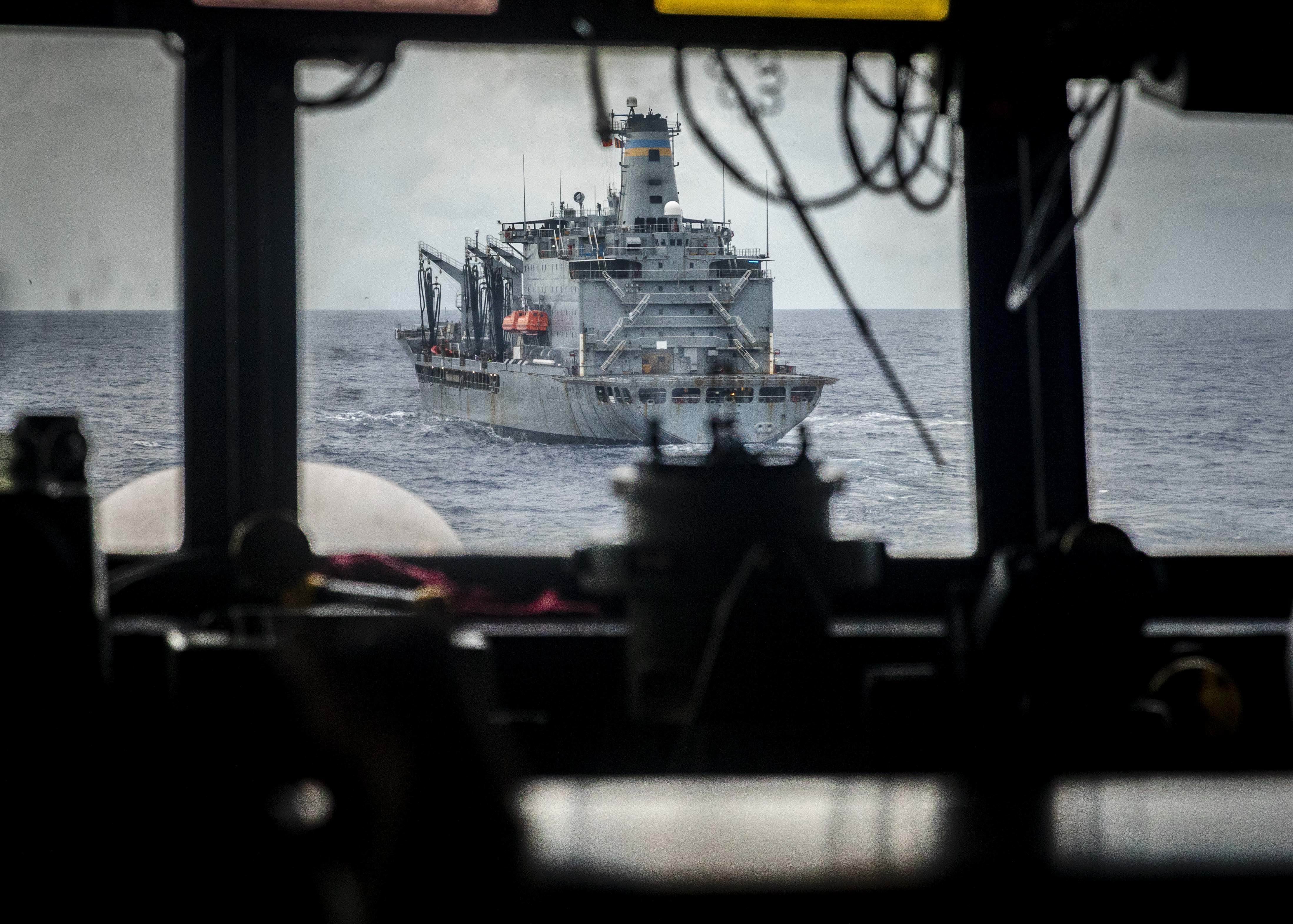 The Arleigh Burke-class guided-missile destroyer USS John S. McCain (DDG 56) prepares to come alongside the fleet replenishment oiler USNS Tippecanoe (T-AO 199) for a replenishment-at-sea.